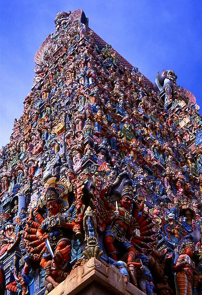 One of the towers (gopuram) at the enwalled meenakshi temple city. The extremely rich bubble-gum coloured ornamentation with sculptures depicting demigods and other spiritual beings photo: NeilsPhotography, ccbysa2.0
